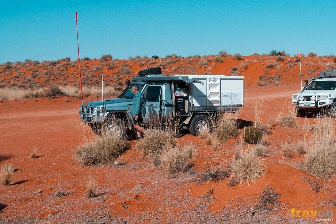 Toyota 79 Series Landcruiser Ute in simpson desert with a Trayon Slide on camper on its tray. Red sand.