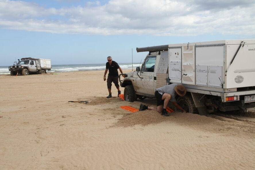 West Coast of Tasmania Sandy Cape Track 4WD Landcruiser bogged stuck on beach.