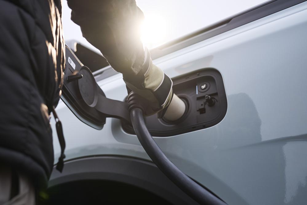 Close-up of a person plugging in a charging cable to the Ford Ranger Plug-In Hybrid.