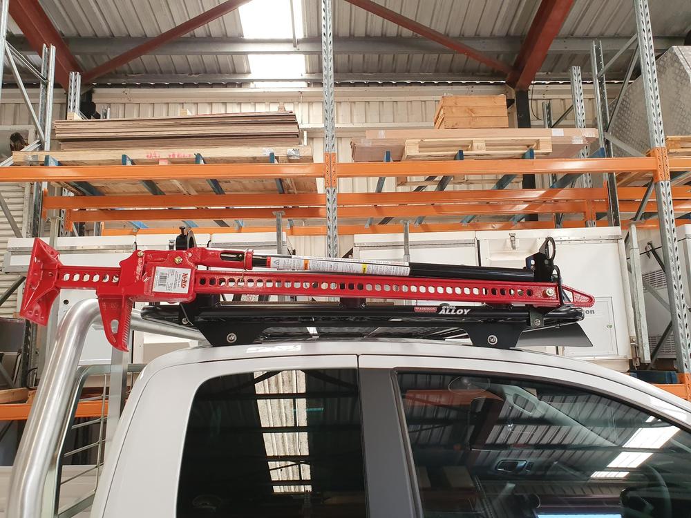 a truck with a ladder on top of it in a warehouse